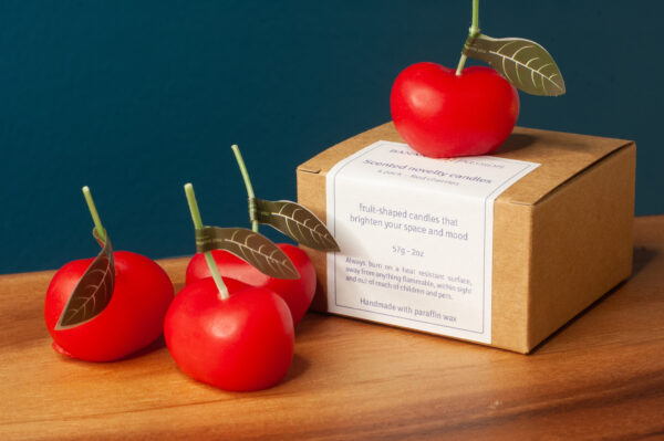 4 red cherries with a packaging box
