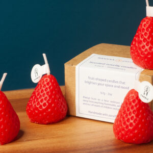 Four strawberry candles with it's packaging box