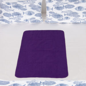 Purple medium Waterproof blanket on bed. These sex blankets are leakproof, 100% waterproof.