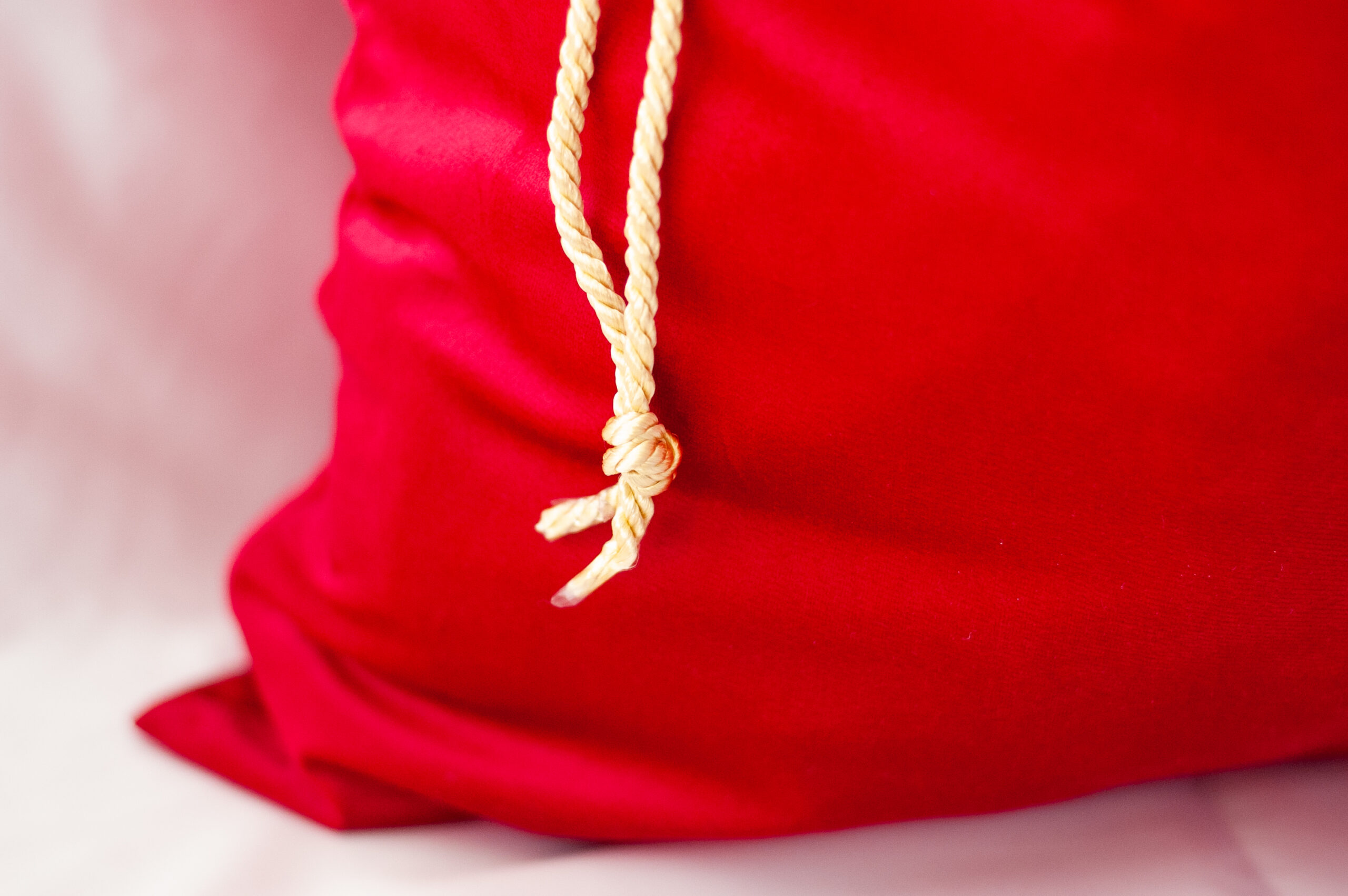 Red Santa Sack made of Velvet and can see golden twisted rope