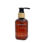 Relaxing massage oil which is warm and soothing. There is some oil being poured on the bottle. It is a 120ml bottle from Banana passion brand