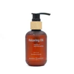 An amber plastic bottle with a bamboo looking pump contains 120 ml Relaxing Body Massage Oil. Its handmade in Australia by Banana Passion. Bottle has some water droplets on it to make it look sensational