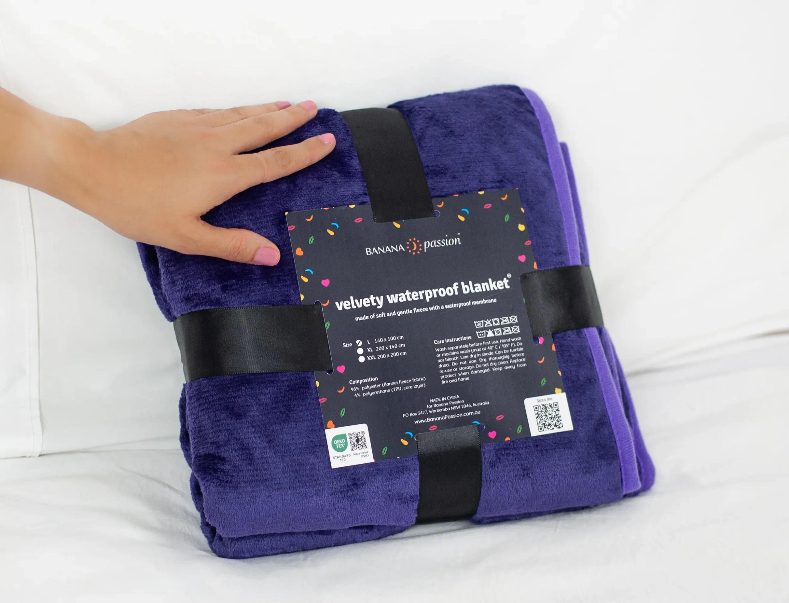 Purple Waterproof Blanket packaging which is black ribbon and a card. This is minimalistic packaging for a waterproof blanket. Best squirt blanket, waterproof intimacy blanket.