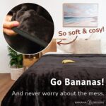 Banana Passion black waterproof blanket on a neatly made bed with the words “Never worry about the mess” highlighting stress-free intimacy and easy clean-up.