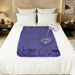 Purple Banana Passion waterproof blanket in large size spread over a bed, showing the cosy polar fleece surface and discreet waterproof intimacy blanket design that keeps sheets dry during wet, splashy moments.