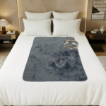 Grey velvety waterproof blanket in large size spread neatly over a bed, showing the soft flannel fleece intimacy blanket surface that keeps sheets dry during wet, splashy moments. This Banana Passion sex blanket is the best blanket in town.