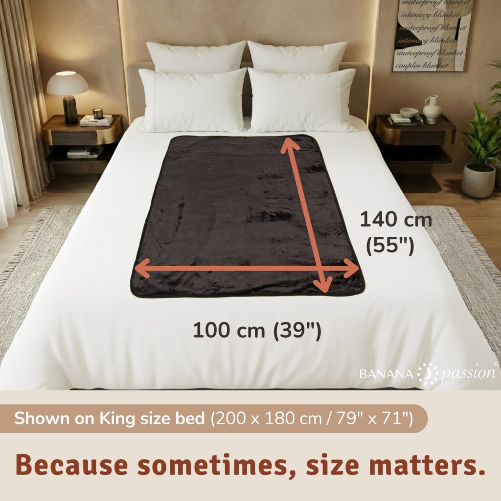 Large waterproof blanket for bed intimacy laid flat on a neatly made bed, showing the soft flannel fleece surface on both sides, designed as a reusable sex blanket, love blanket and splash blanket to keep sheets dry and stain free. Can be used as pet blanket or kids waterproof blanket