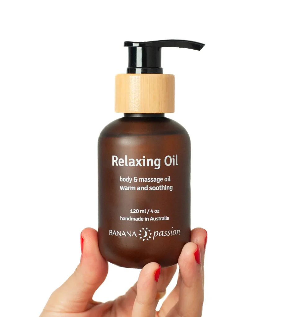 Banana Passion Relaxing Massage Oil—soft, soothing oil with sandalwood and musky wood scents, perfect for relaxing muscles, calming stress, body wellness, and couples’ massage rituals.