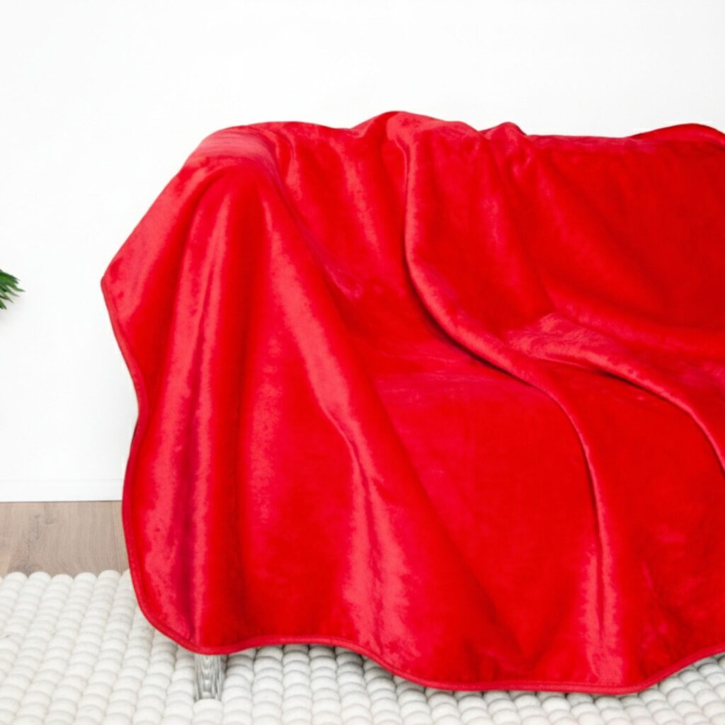 Red waterproof intimacy blanket on bed. This is Banana Passion waterproof sex blanket. Stay in the moment with our red waterproof intimacy blanket that stops spills reaching your sheets.