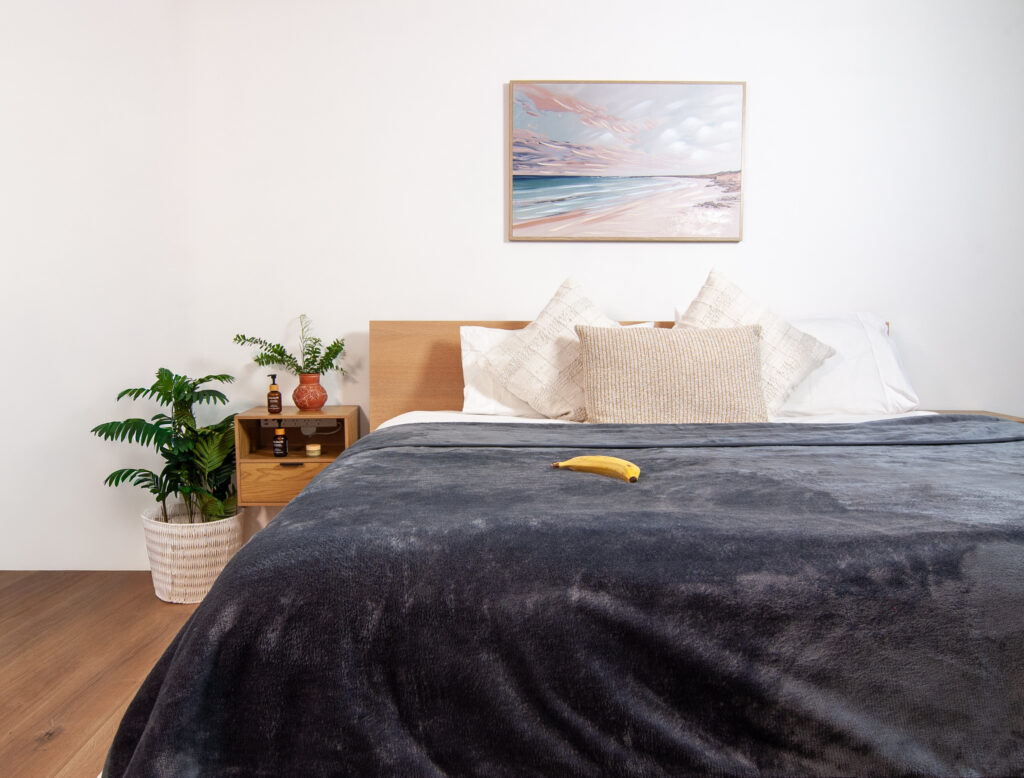 Purple Waterproof Blanket in the hands of a woman showcasing it is soft. This is exactly like squirt blanket or liberator throw. Best squirt blanket.