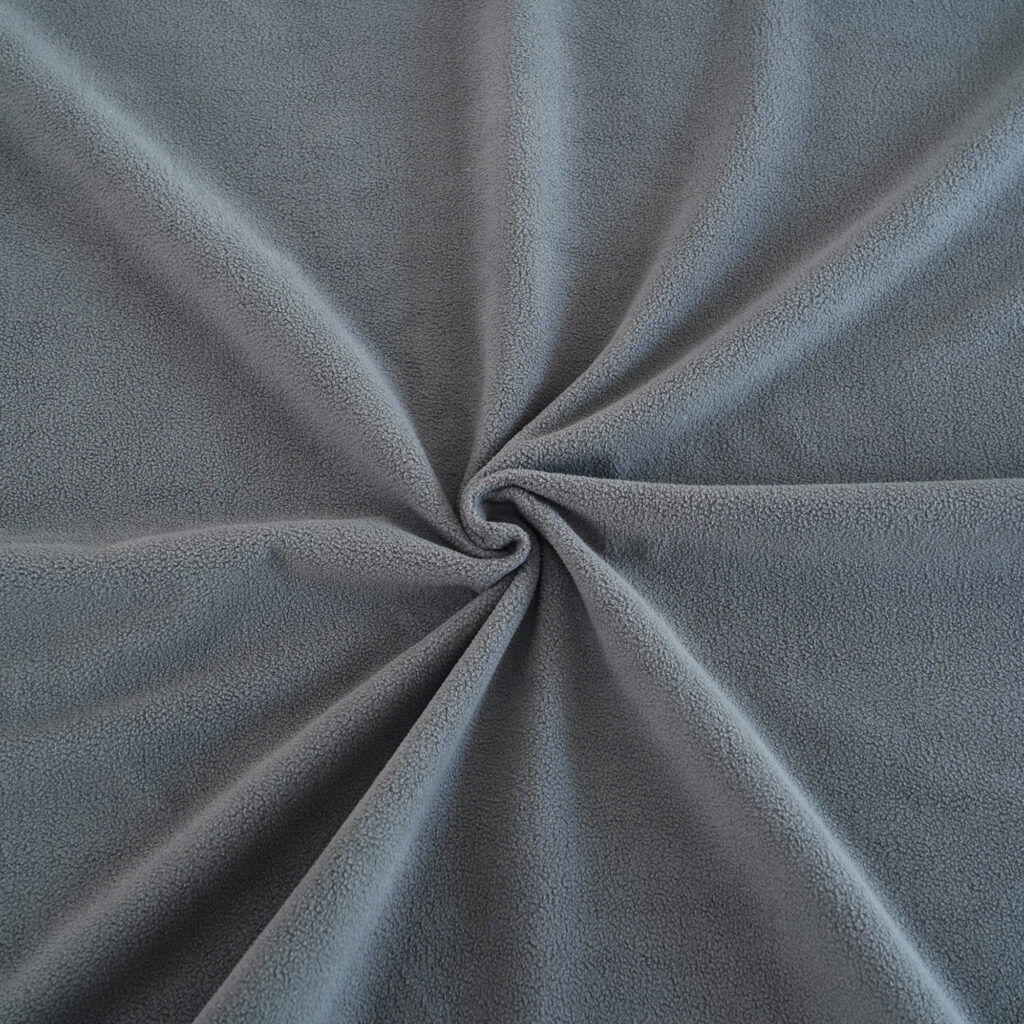 Purple Waterproof Blanket in the hands of a woman showcasing it is soft. This is exactly like squirt blanket or liberator throw. Best squirt blanket.