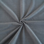 Purple Waterproof Blanket in the hands of a woman showcasing it is soft. This is exactly like squirt blanket or liberator throw. Best squirt blanket.