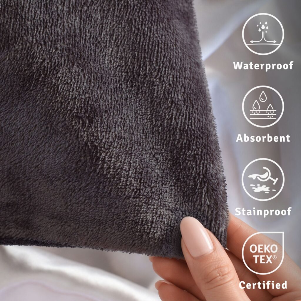 Texture of the splash proof protector - grey in colour. This is waterproof, absorbent, stainproof and oeko tested. Charcoal grey flannel fleece fabric close-up, waterproof pillow protector