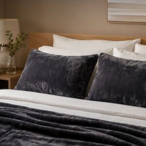 Dark grey waterproof pillow protectors on a bed, soft flannel fleece fabric