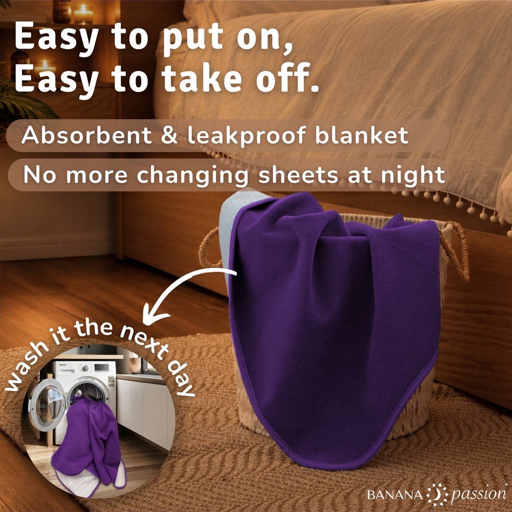a gripme waterproof blanket in a laundry basket next to a bed oin a bedroom showcasing that you don’t need to worry about sheet change, just throw the blanket in the washing and wash tomorrow.